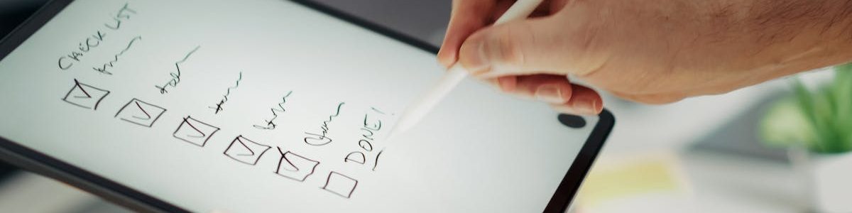 pexels-photo-33266834-33266834 Close-up of a hand writing on a digital checklist using a stylus on a tablet, enhancing productivity.